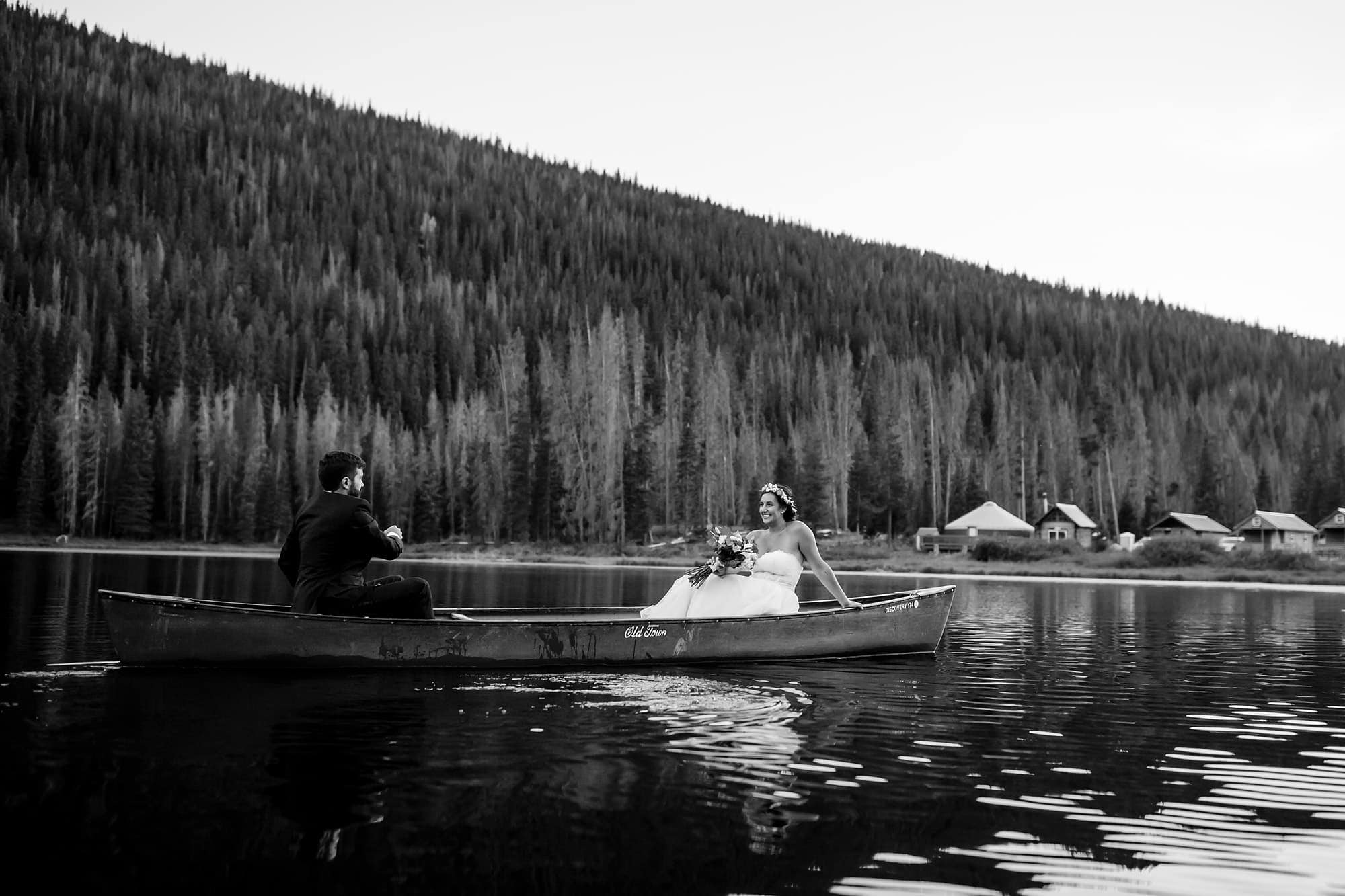 Becky and Brian row in a canoe on Piney Lake during their wedding in September outside of Vail, Colorado.