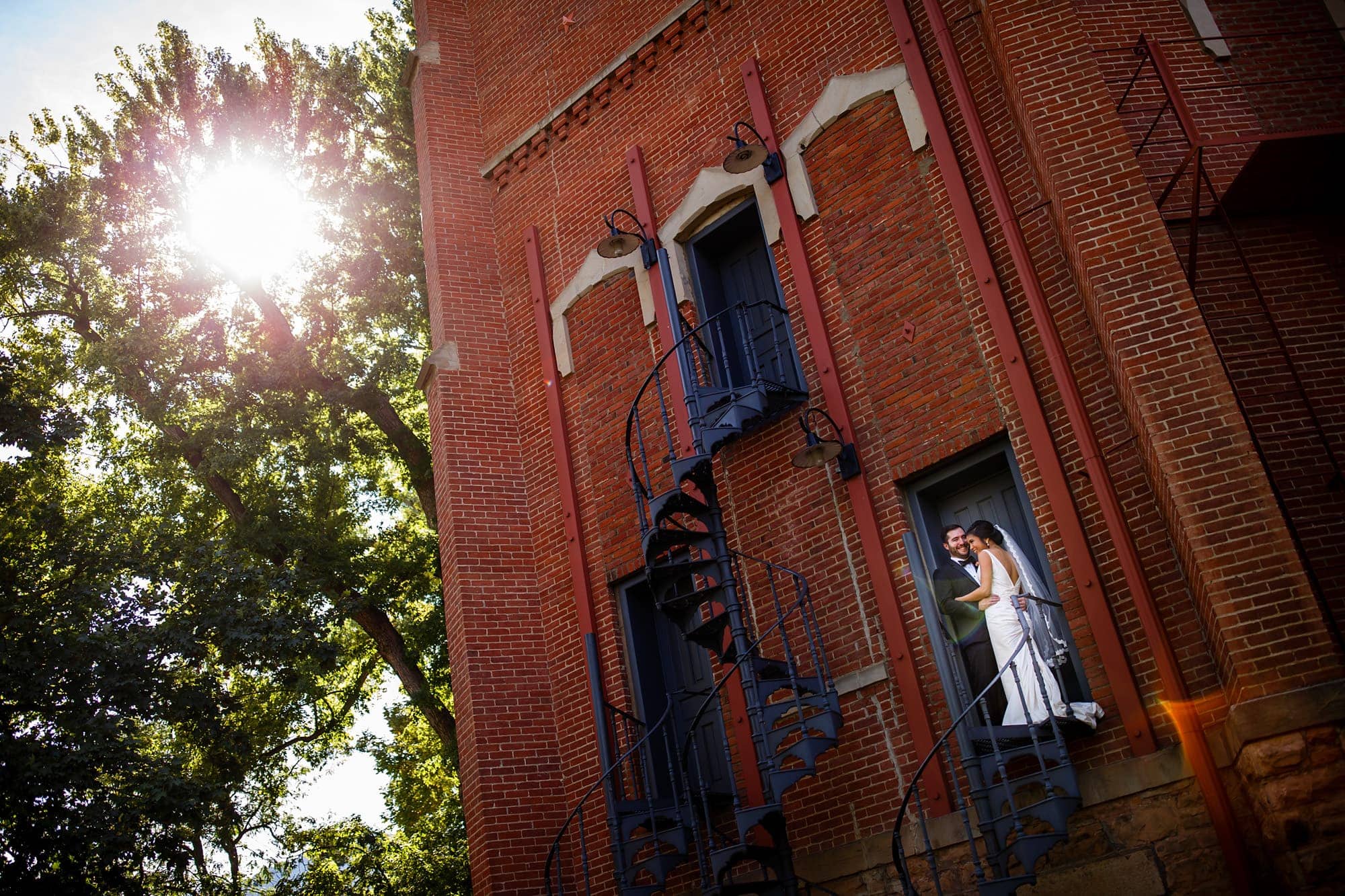 Megan and Bryan pose on the staircase of Old Main on the University of Colorado campus before their wedding