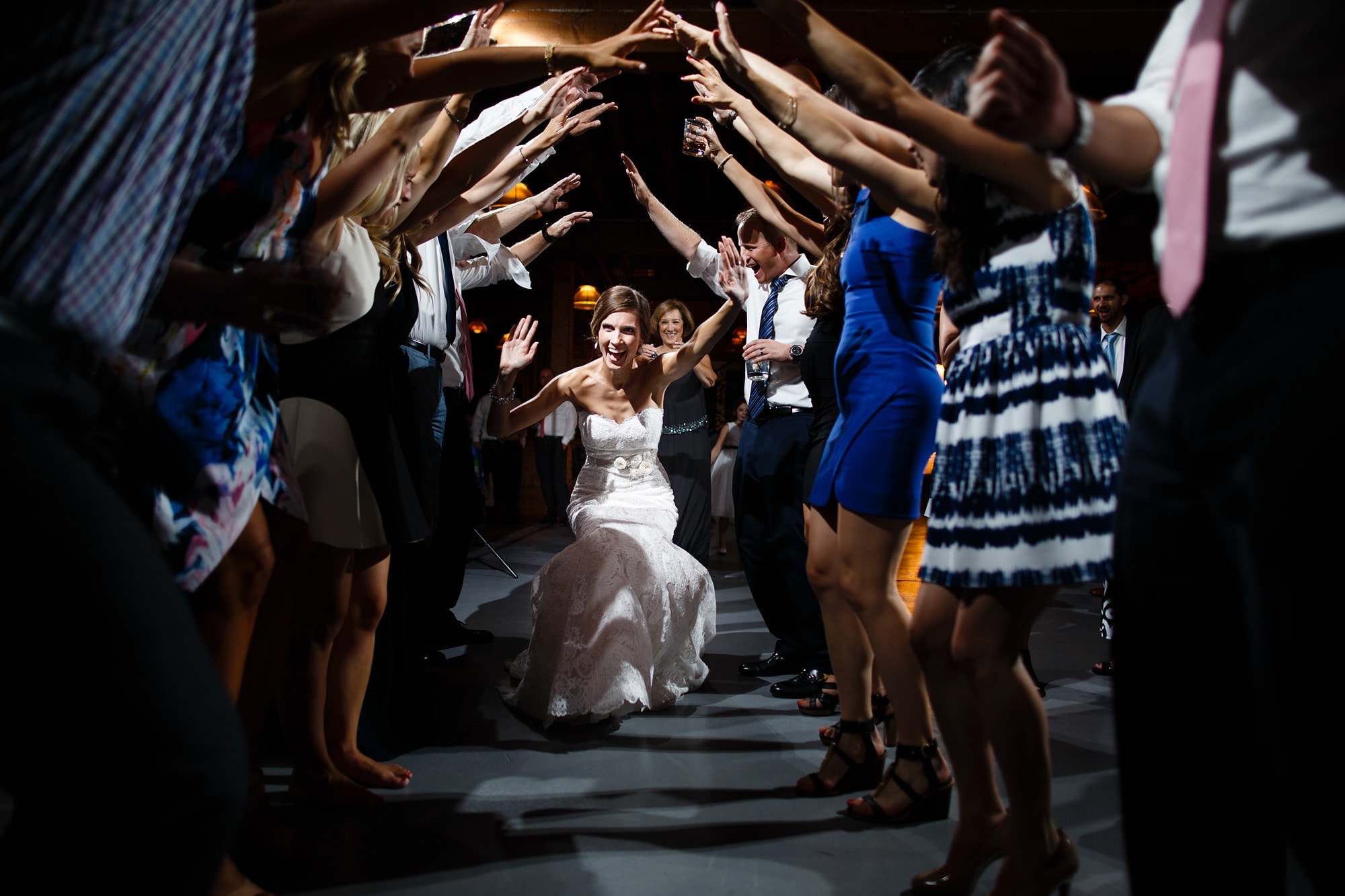 Kara dances through a tunnel of guests during her wedding at Architectural Artifacts in Chicago.