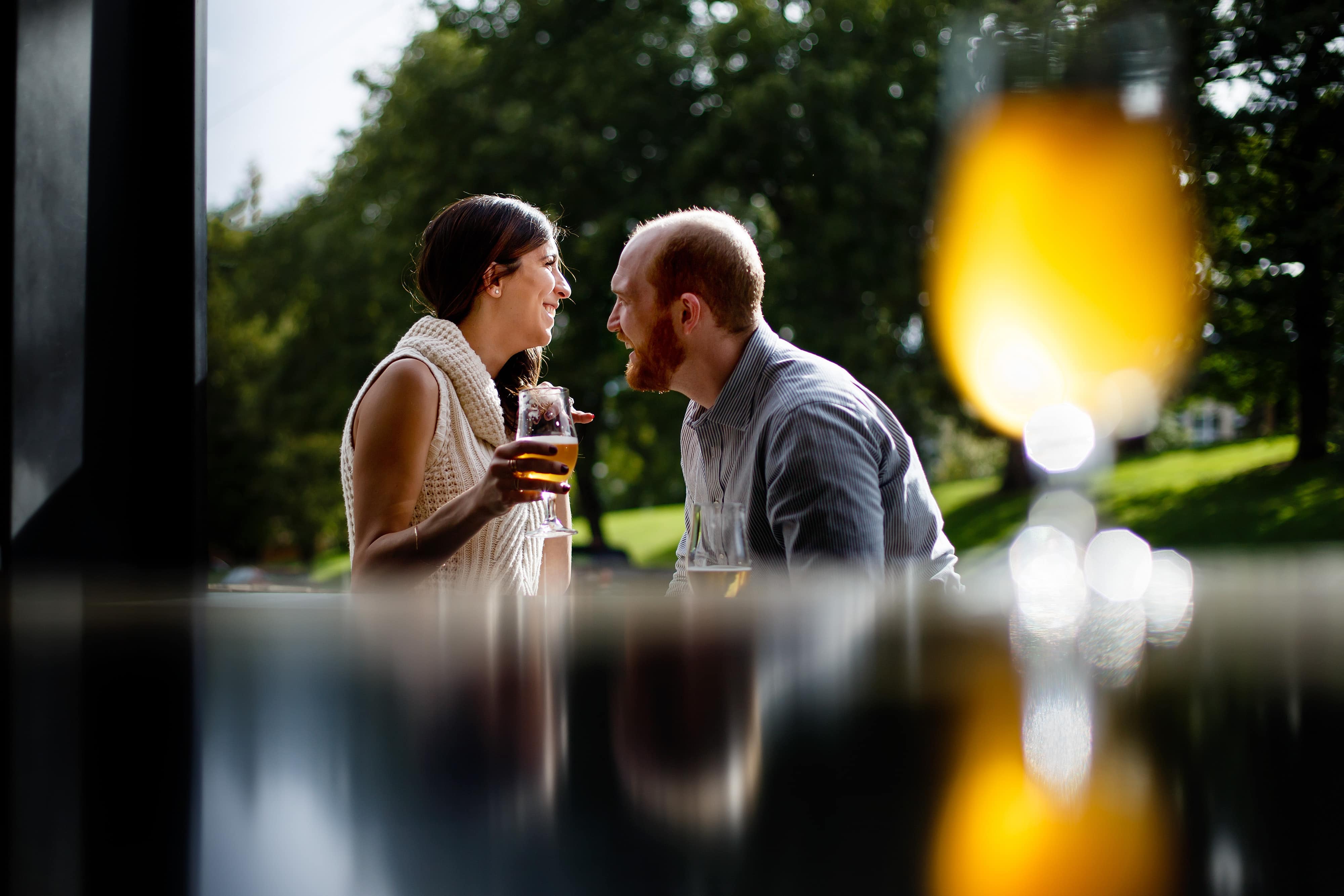 Angie and Chris enjoy a beer at Briar Common Brewery during their engagement session near Jefferson Park