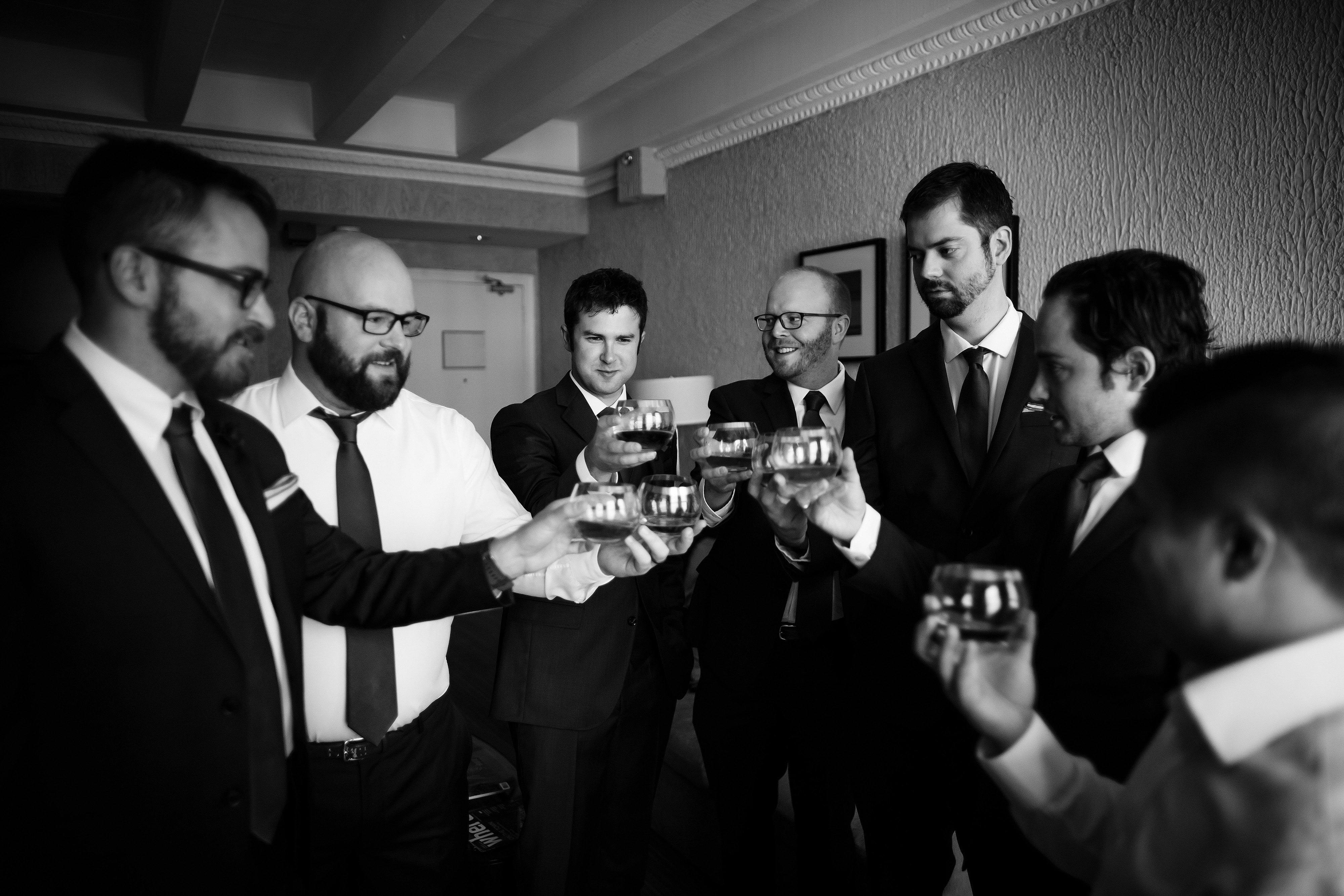 The groom and groomsmen share a drink before the ceremony