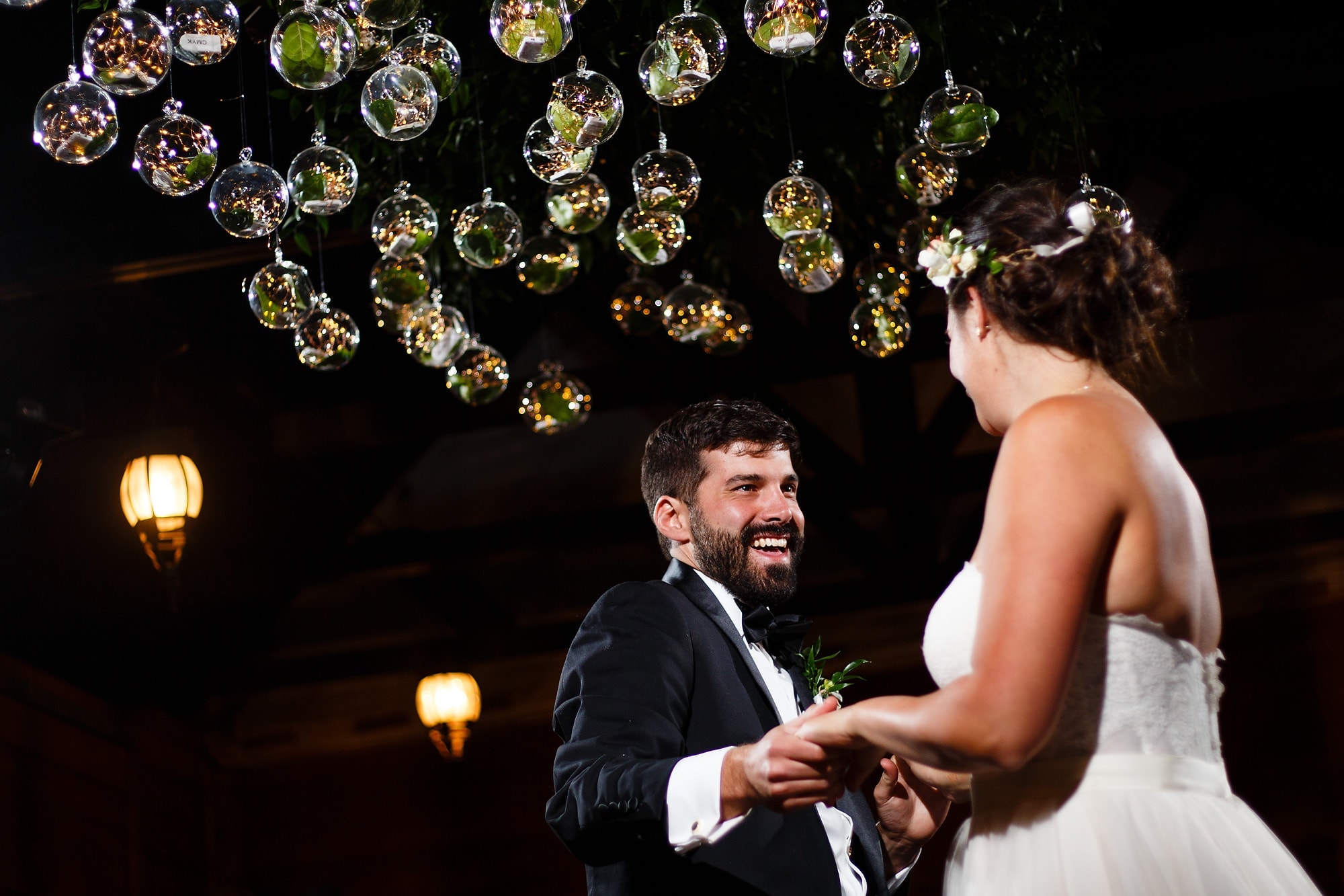 The Bride and groom share their first dance surrounded by glass globes at the reception at Piney River Ranch near Vail, Colorado.