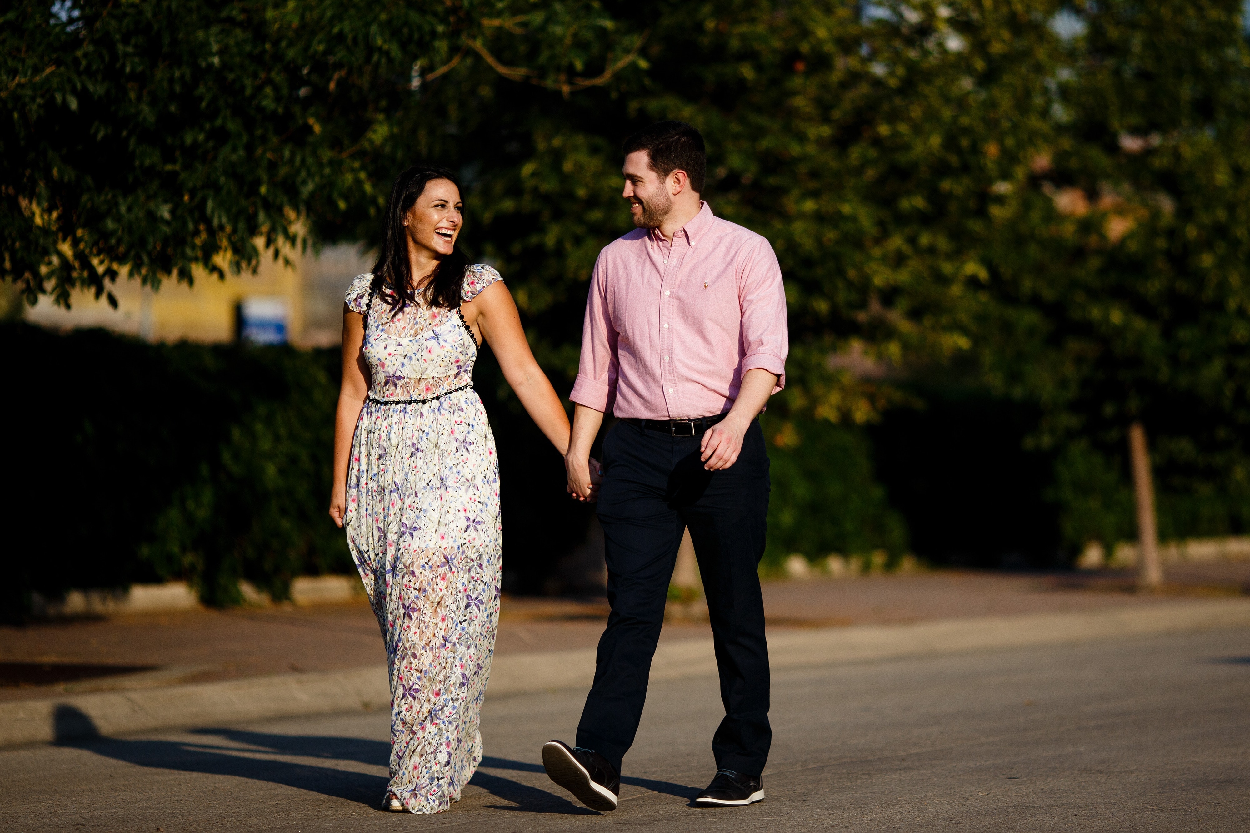 Danielle and Jordan walk together in lower downtown Denver during their engagement photos
