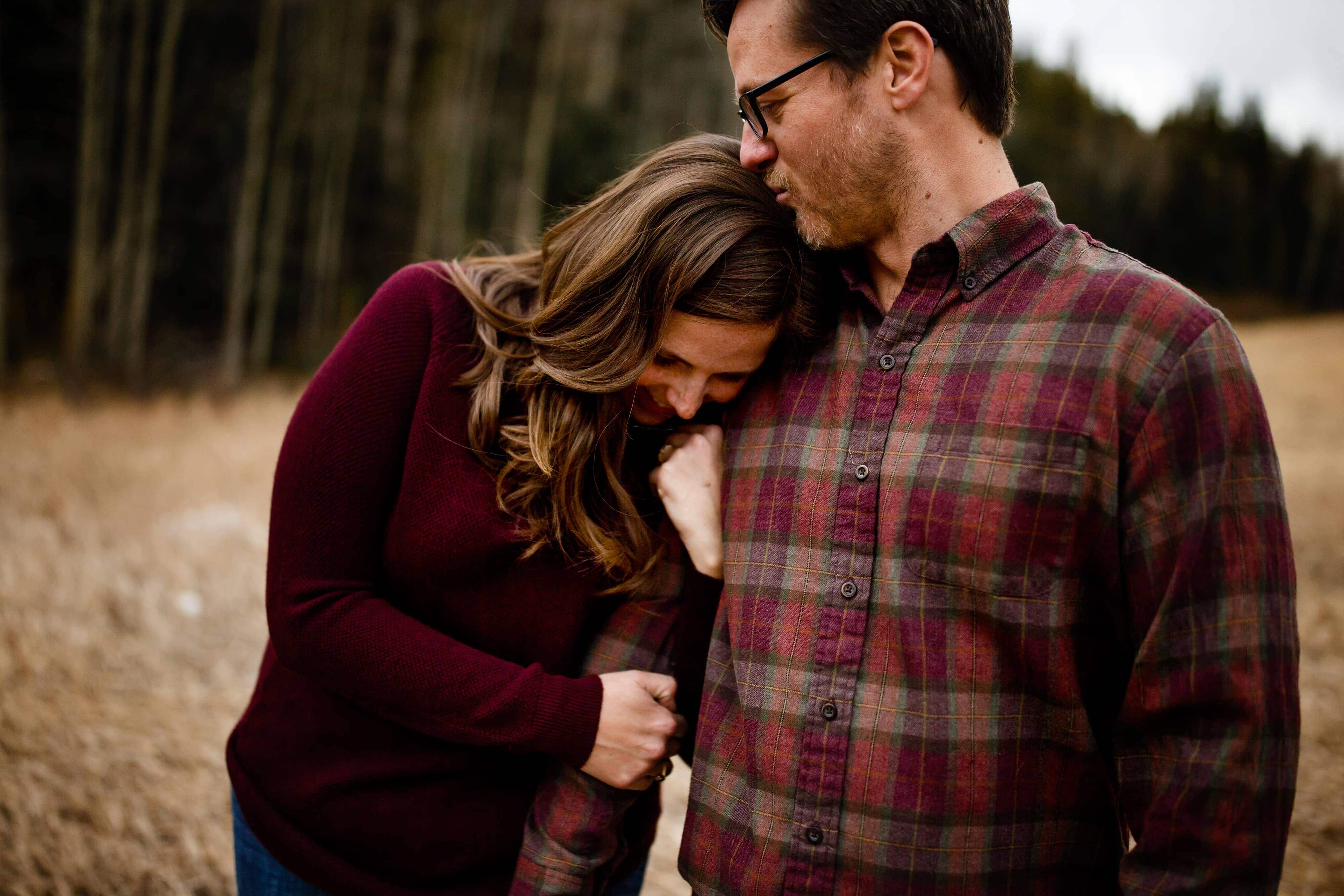 Kate and Brian try to keep warm during their spring engagement session at Golden Gate Canyon State Park