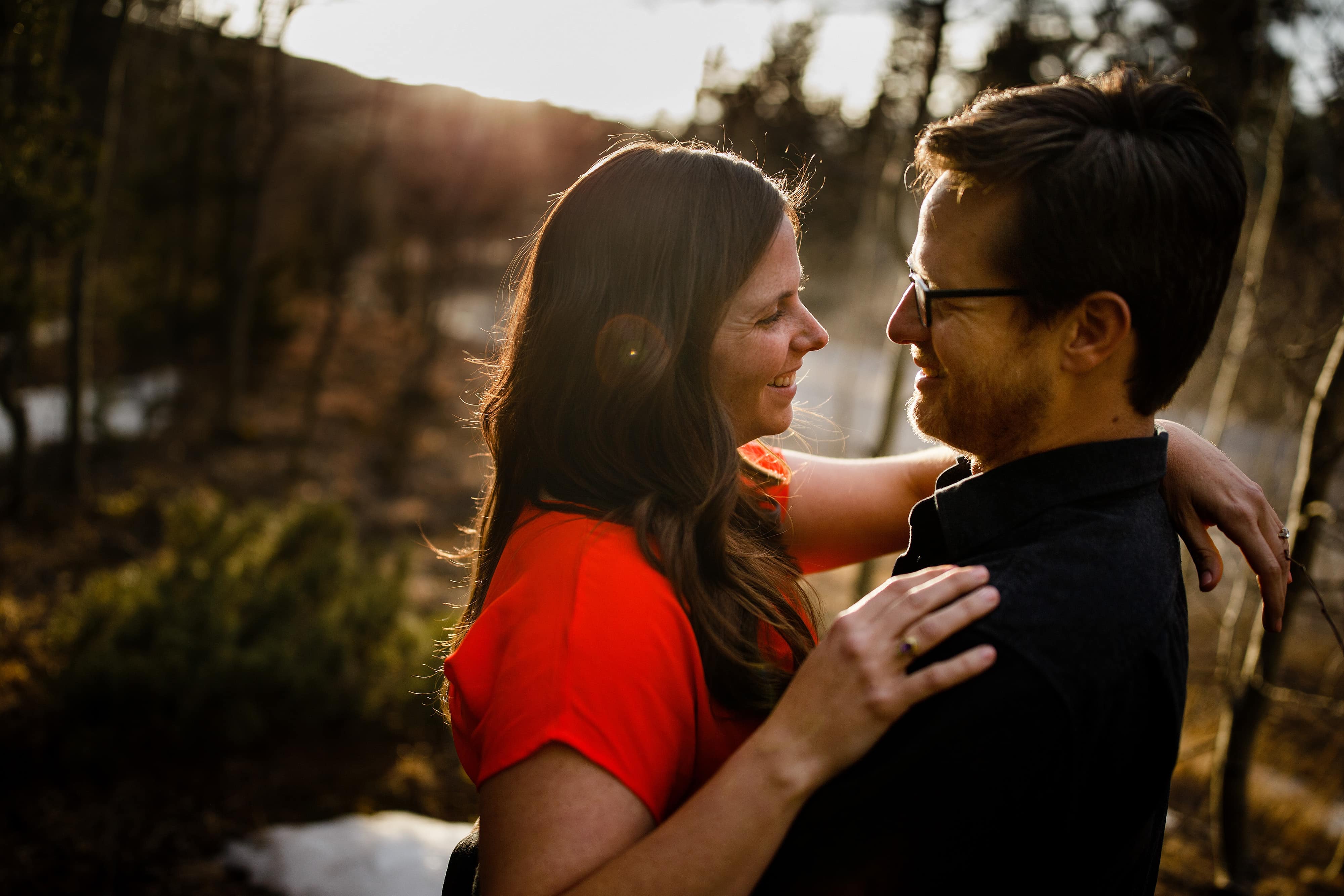 Briand and Kate embrace in a grove of aspens during their spring engagement session near Golden Gate Canyon State Park