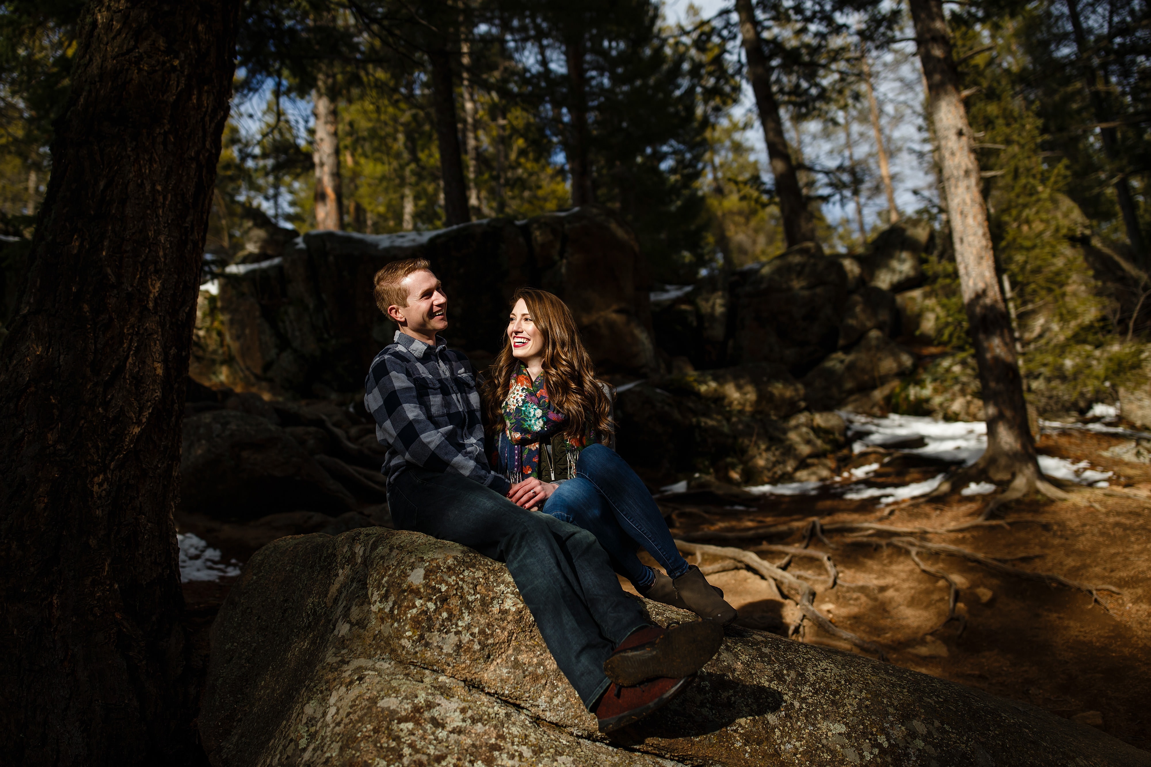 A couple shares a laugh at Maxwell Falls during their Evergreen engagement session