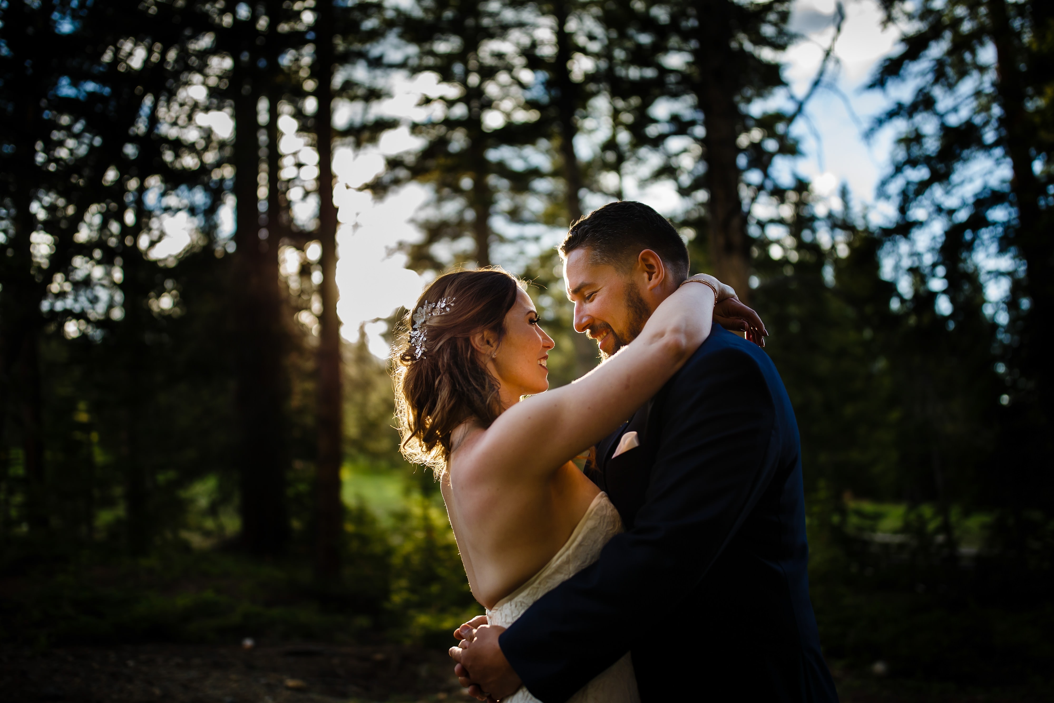 Sharon and Nick embrace in the evening light during their wedding at TenMile Station on Peak 9 in Breckenridge
