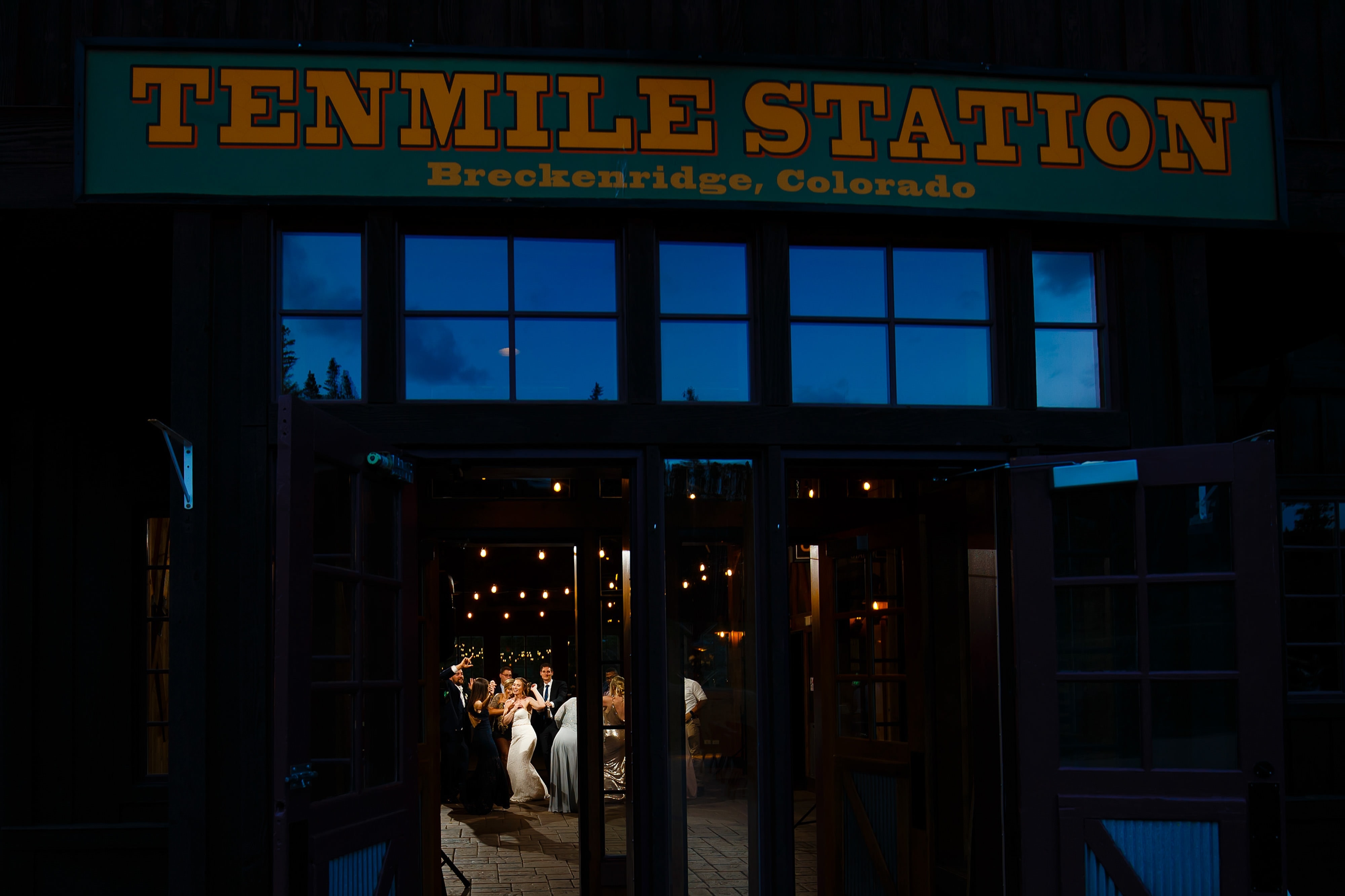 The bride dances with guests during her summer wedding at TenMile Station