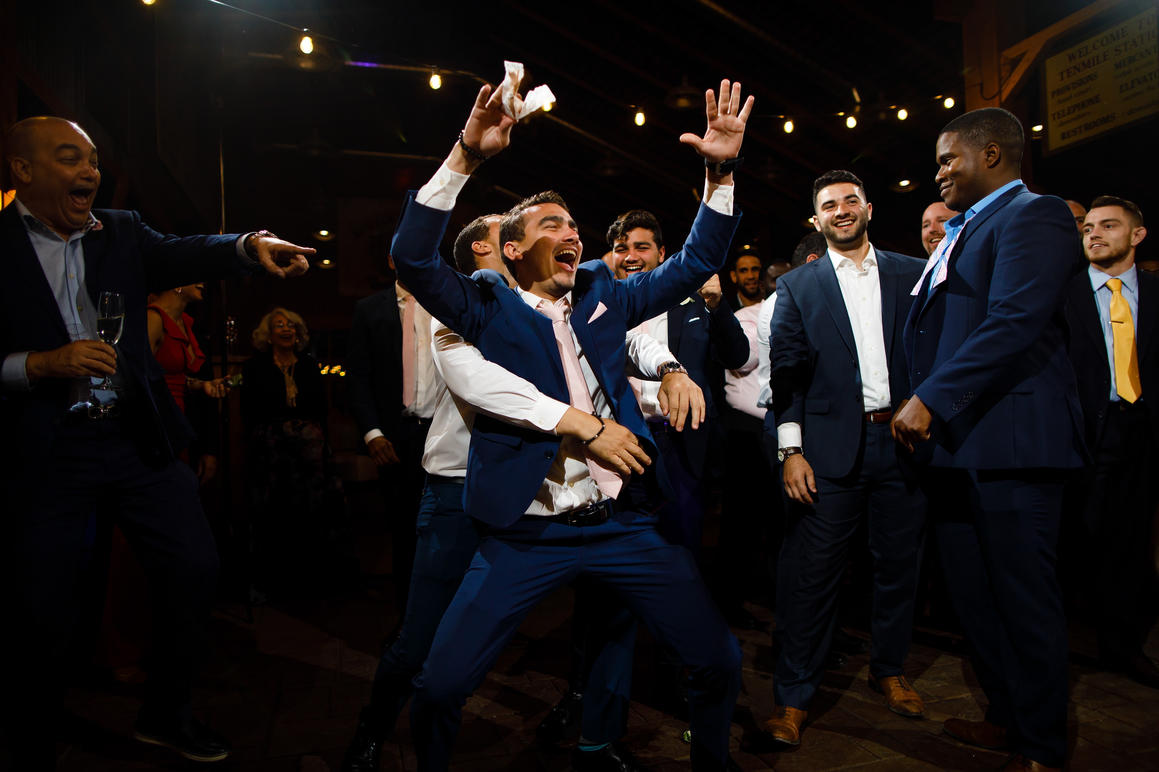 A groomsmen celebrates after catching the garter