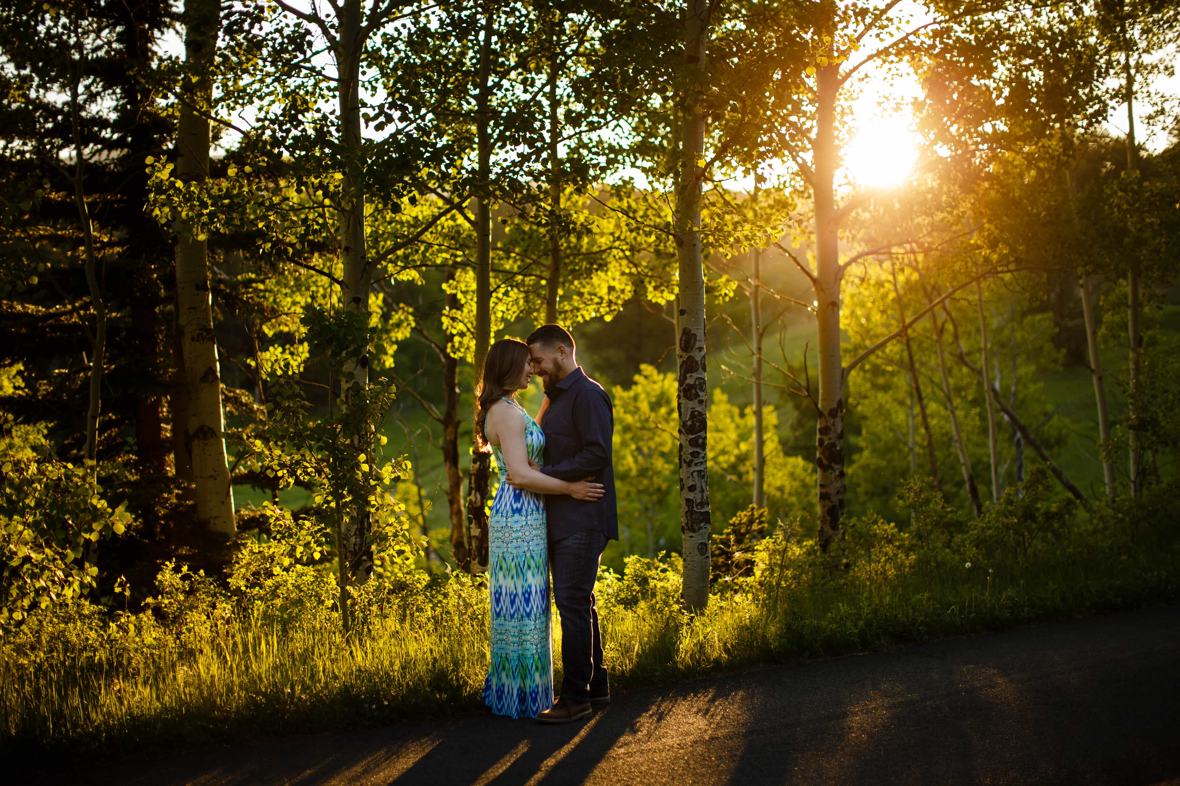 Sharon and Nick share a moment on Mountain Base Road during their colorful engagement in Golden Gate Canyon State Park