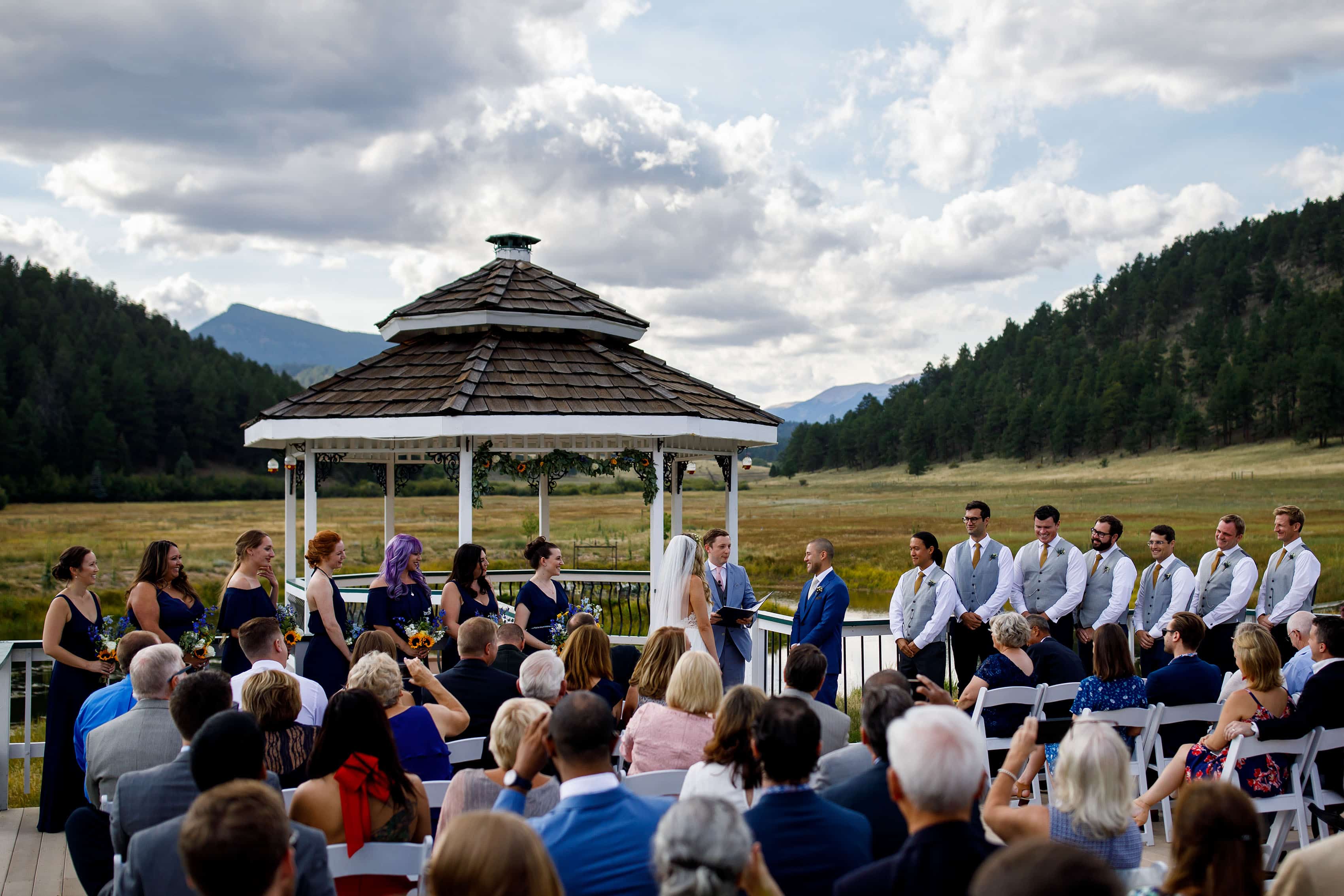 The ceremony takes place at the gazebo during a summer wedding at Deer Creek Valley Ranch