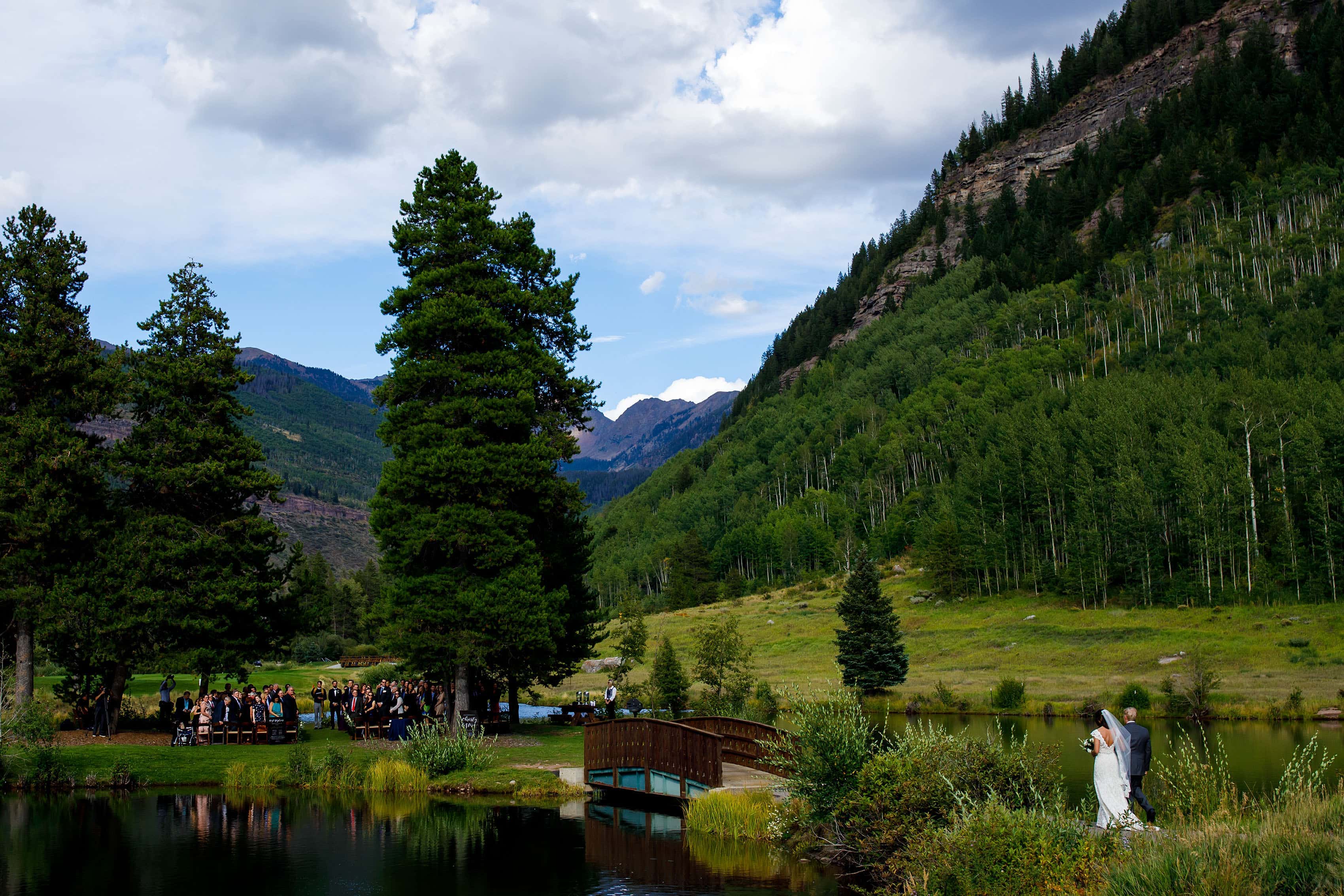 The bride walks across the bride during her Vail Golf Club wedding