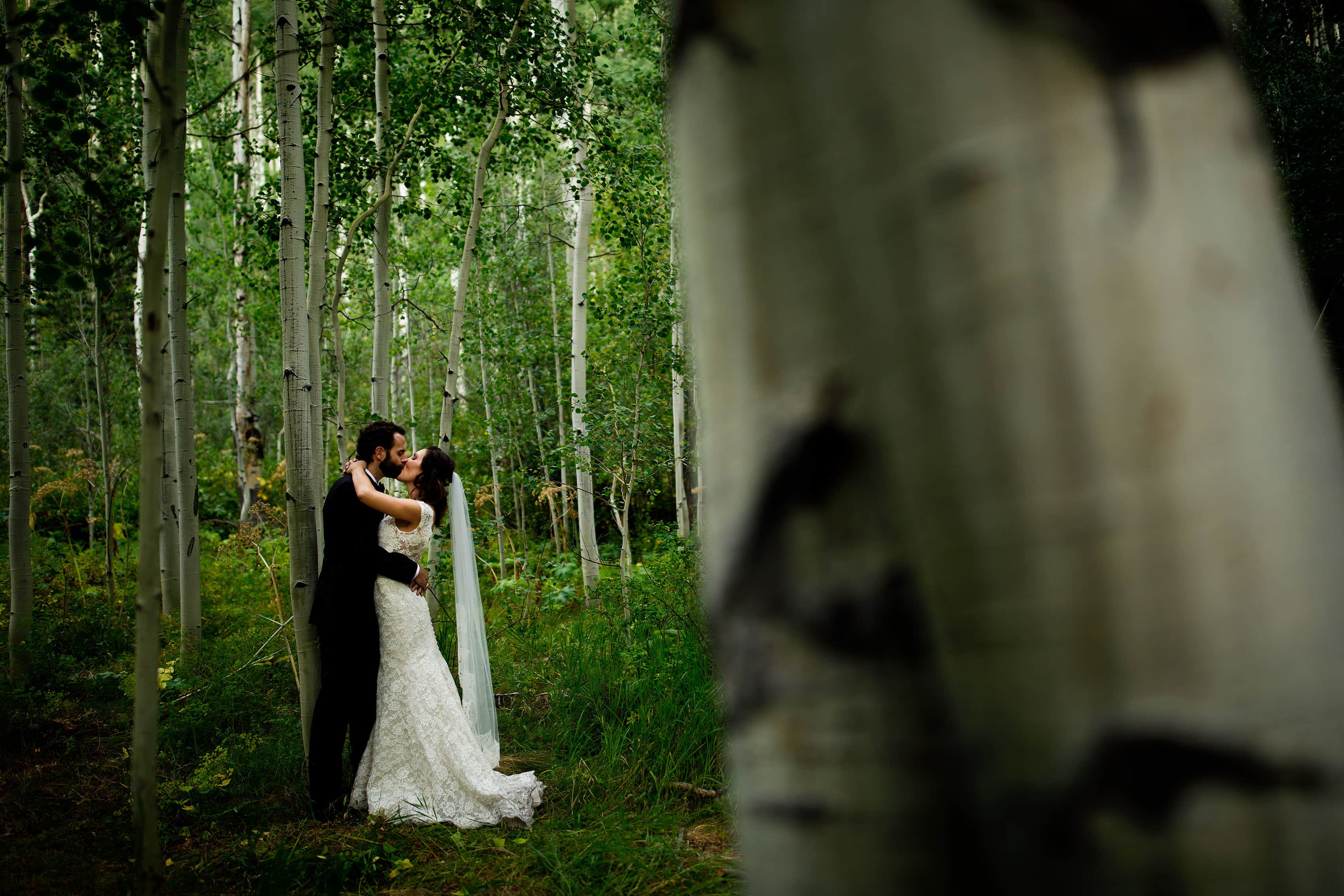 The couple share a kiss after their wedding in Vail