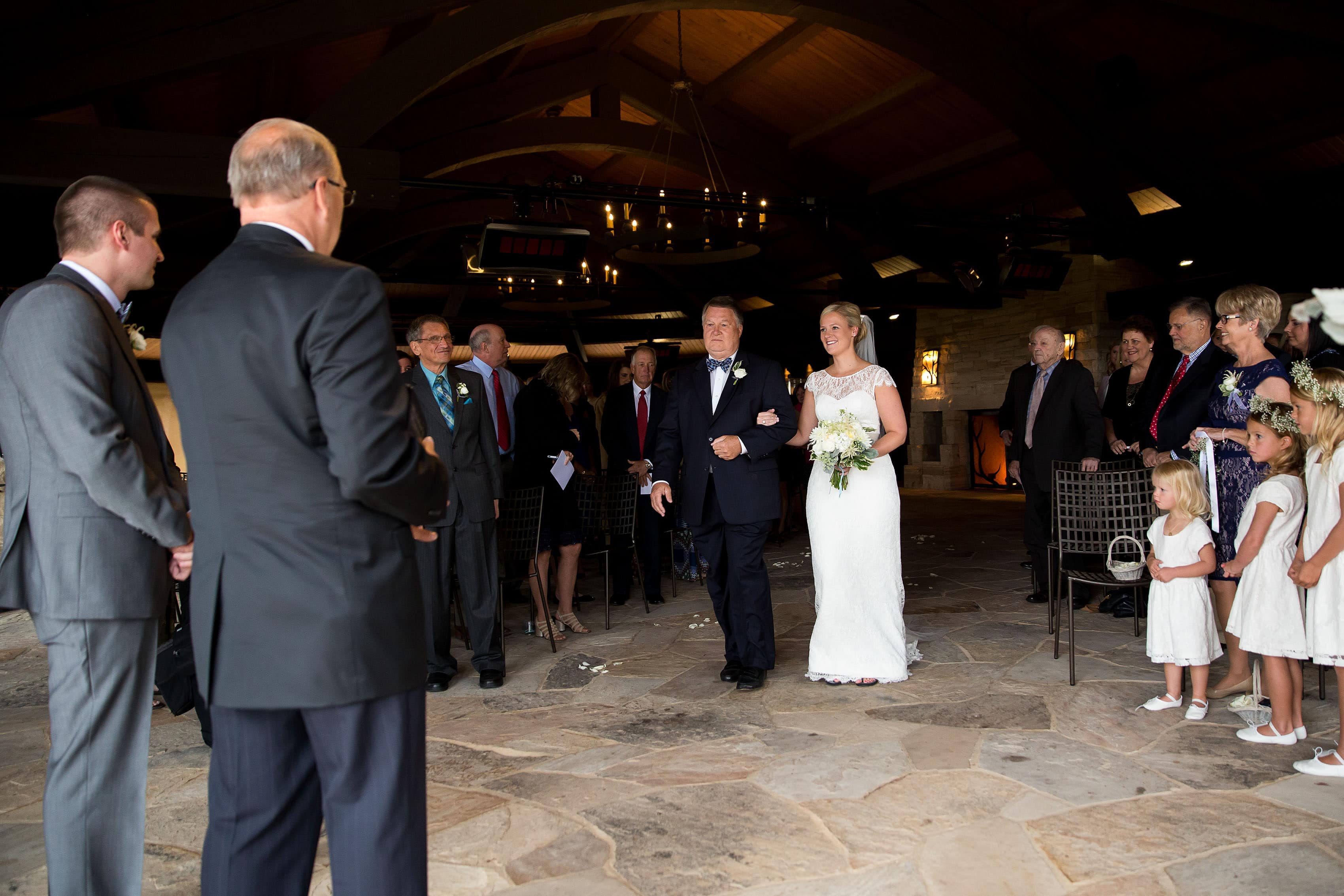 Bride walks down the aisle during a Sanctuary Golf Course wedding