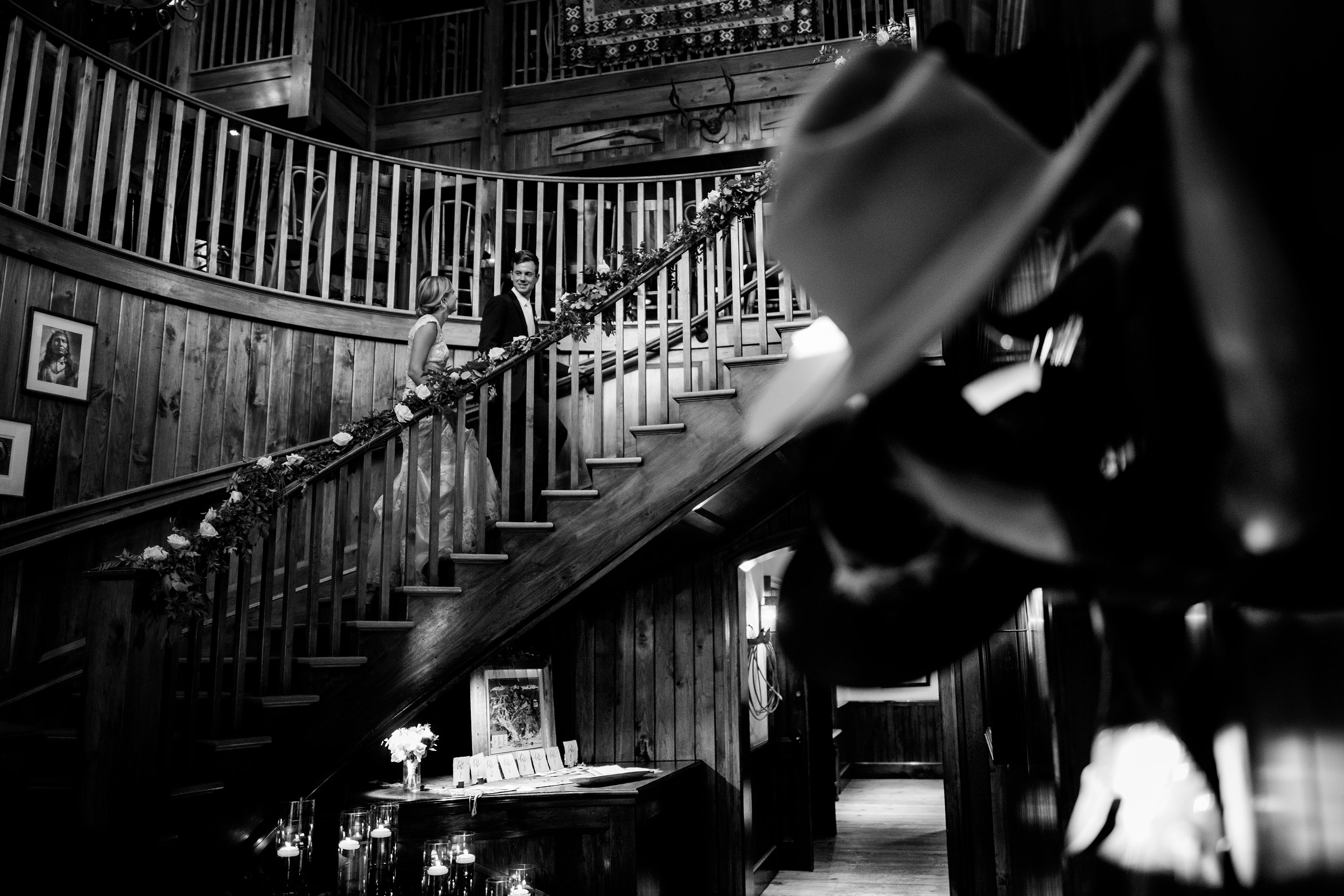 The newlyweds climb the spiral staircase at Saddleridge