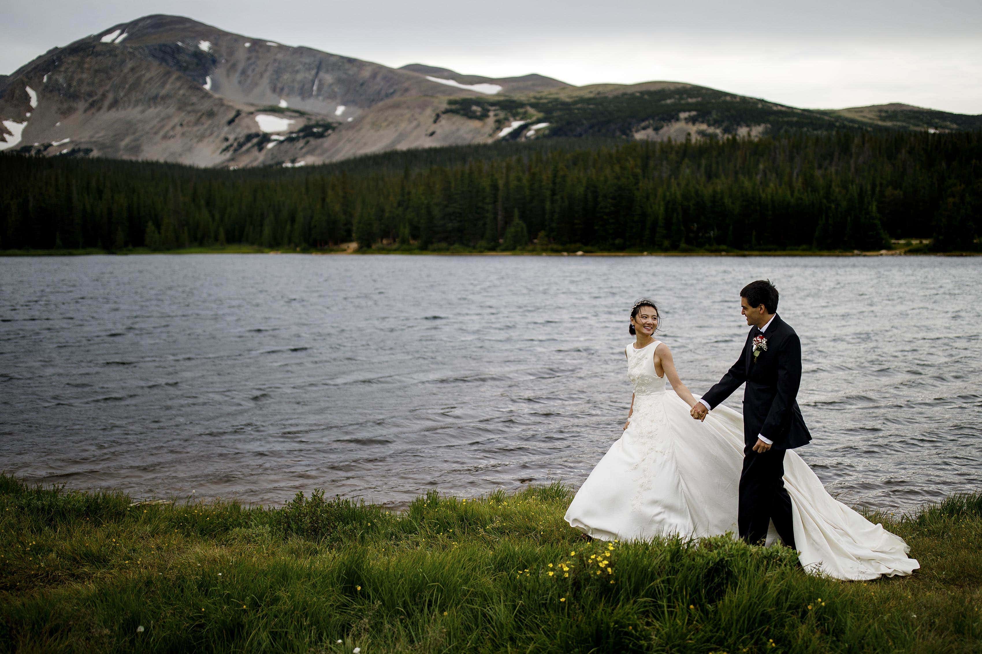 Cecelia walks with Jamie along the shore of Brainard Lake in Ward, CO during their elopement