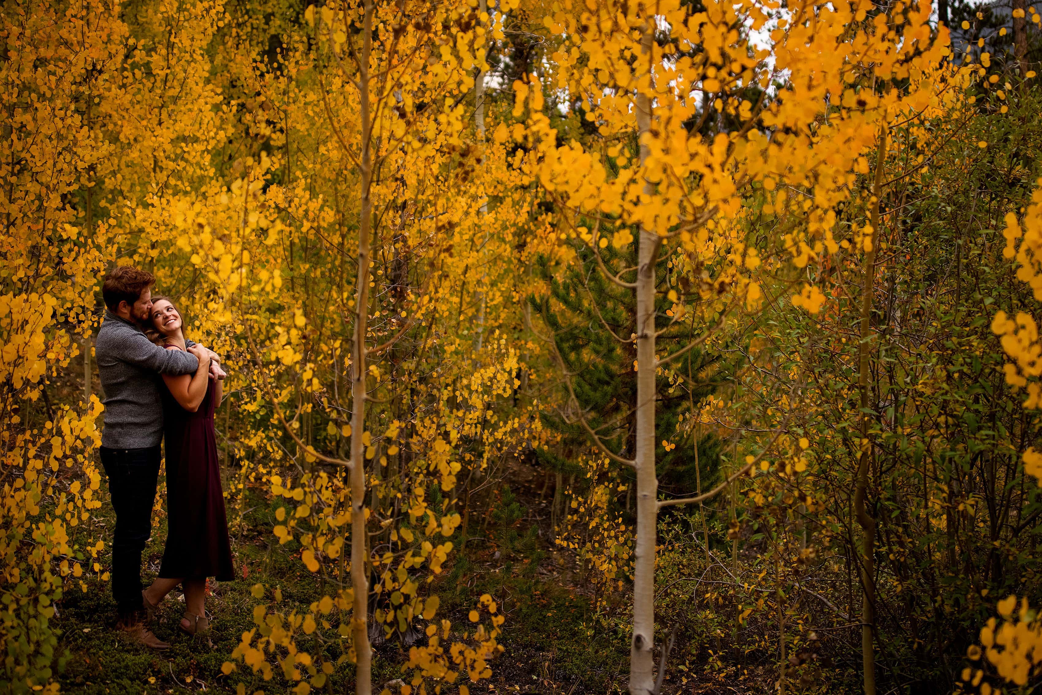 Darren and Casey enjoy a moment together while surrounded by colorful aspen trees
