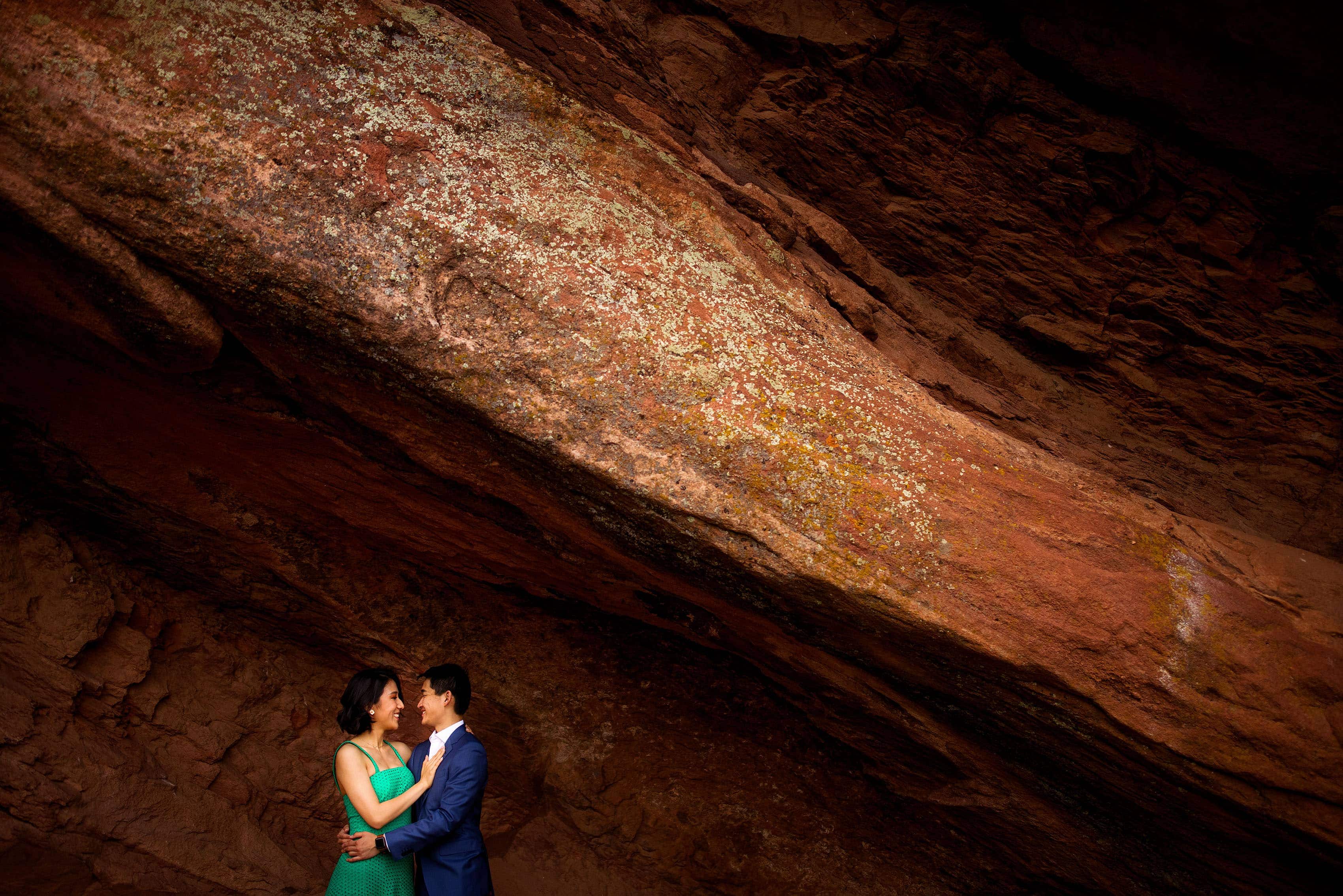 Yufan and Sunny embrace at Red Rocks amphitheatre during their engagement session