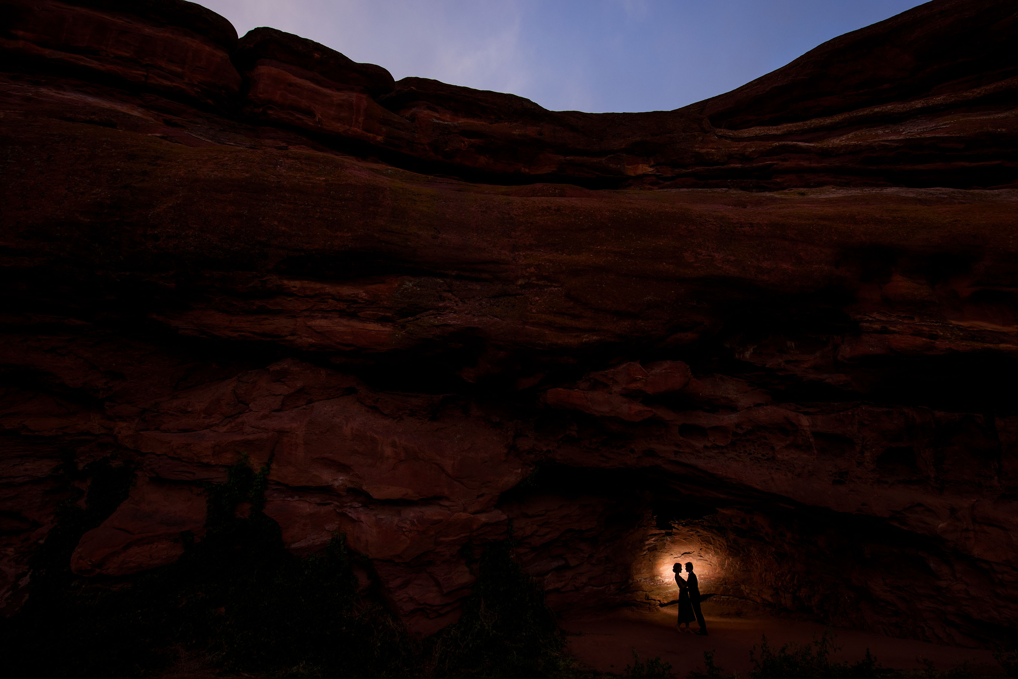 A couple is silhouetted at Red Rocks amphitheatre near Morrison, COlorado